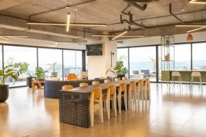 a conference room with chairs and tables and windows at Tropical Apartment in the city in Guatemala