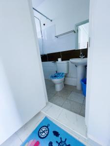 a bathroom with a toilet and a sink at Classy two bedroom Airbnb with swimming pool in Kiambu