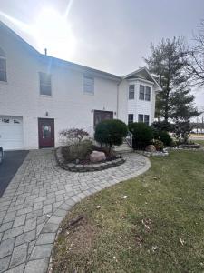 a house with a brick driveway in front of it at EdisonHollywood in Edison