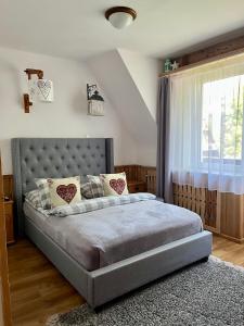 a bedroom with a bed and a window at Marina Zakopane in Zakopane
