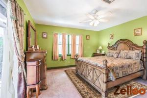 a bedroom with green walls and a bed and a ceiling fan at Experience Coastal Living at its Best Florida Keys in Summerland Key