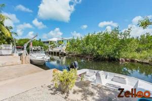 a boat is docked at a dock in the water at Experience Coastal Living at its Best Florida Keys in Summerland Key