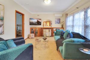 a living room with two couches and a fireplace at GATSBY walk to Geelong CBD and Waterfront in Geelong