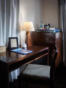 a desk with a lamp and a book on it at Shambaling Boutique Hotel in Kathmandu