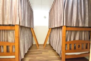 two bunk beds in a room with curtains at Dongjin B&B in Taimali
