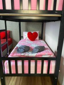 a bunk bed with two pillows and a heart pillow at Sabaidee Pool Villa Cha-am in Cha Am