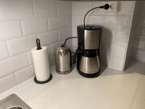 a coffee maker and a roll of paper towels on a counter at Welhavensgate 3A in Oslo