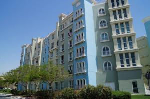 a tall blue building with white windows and trees at Discovery Gardens Haven Studio Units in Dubai