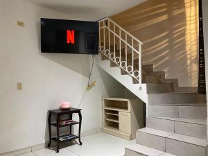 a staircase with a sign with the letter n on it at Spacious Rooftop House w/ King Bed in Tijuana