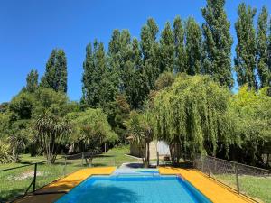 a swimming pool in a yard with trees at Cabañas Mi Quincho in Parral