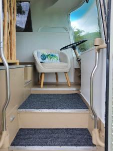 a small room with a chair in a van at Le Big Bus 