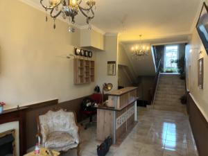 a living room with a staircase and a chandelier at CITY HOUSE in Dulovo