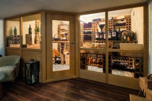 a room with a wine cellar with glass doors at Antoniushof - inklusive Super Sommer Card in Serfaus