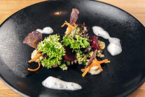 a black plate of food on a table at Antoniushof - inklusive Super Sommer Card in Serfaus