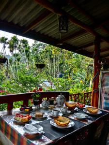 a table with food and a tea pot on it at Cozy Homestay Waterfall Road Ella in Ella