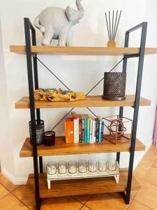 a shelf with a stuffed elephant and other items on it at Old Cleveland Views - Stones Corner in Brisbane