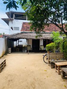 a patio of a house with a table and chairs at Anosha Villa in Weligama +4 photos