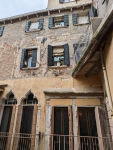 an old brick building with windows and a balcony at My Rialto Palace in Venice