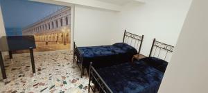 two beds in a room with a large window at My Rialto Palace in Venice