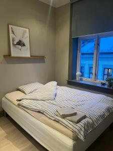 a bed with two towels on it in a bedroom at Welhavensgate 3A in Oslo
