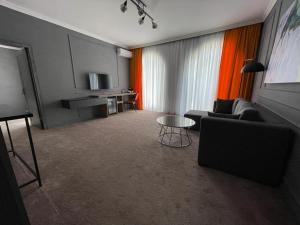 a living room with a couch and a table at Blanco boutique hotel astara in Astara +22 photos