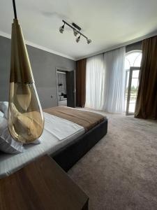 a large bedroom with a large bed with a large vase at Blanco boutique hotel astara in Astara