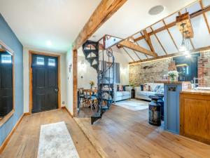 a kitchen and living room with a brick wall at Bockety Barn in Stalham