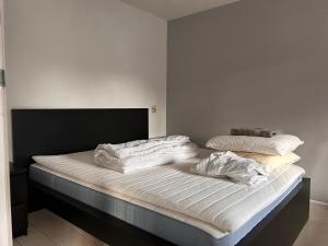 a bed with two pillows on it in a room at Private 3 bedroom apartment - HomeStay Properties Amsterdam in Amsterdam