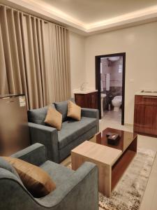 a living room with two couches and a coffee table at دريم بارك العليا in Al Khobar