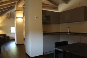 a kitchen and living room in an apartment at PALAZZO DE' ROSSI HOTEL in Sasso Marconi