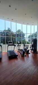 a gym with a bunch of exercise equipment in a room at Apartemen Nuvasa Bay in Nongsa