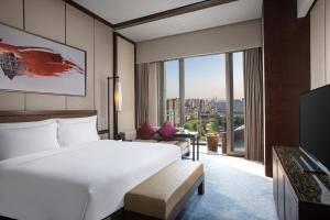 a hotel room with a bed and a large window at Crowne Plaza Chongqing New North Zone, an IHG Hotel in Chongqing