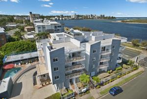 an aerial view of a building next to the water at Sandy Shores Holiday Units in Caloundra
