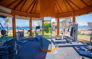 a gym with cardio equipment and a view of the ocean at Nuweiba Club Resort in Nuweiba