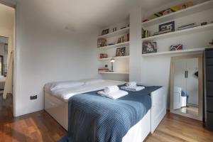 A bed or beds in a room at Giresio 41 - Your Penthouse with Rooftop Garden in Milano Navigli - WIFI