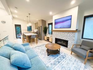 a living room with a blue couch and a fireplace at Ocean View Town House #4 at THE BEACH HOUSE! in Campbell River