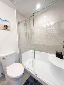 a bathroom with a shower and a toilet and a sink at Ocean View Town House #4 at THE BEACH HOUSE! in Campbell River