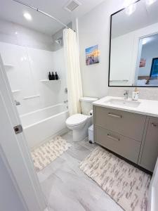 a bathroom with a sink and a toilet and a bath tub at Ocean View Town House #4 at THE BEACH HOUSE! in Campbell River