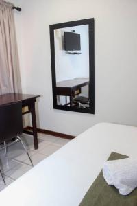 a mirror in a room with a table and a desk at Delta Sunset View in Maun