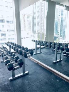 a gym with a row of chairs in front of a window at Cozy Suites at Bukit Bintang City Centre in Kuala Lumpur