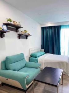 a bedroom with a bed and a chair and a table at Cozy Suites at Bukit Bintang City Centre in Kuala Lumpur