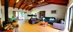 a living room with couches and a table and a kitchen at The Bower in Kalorama