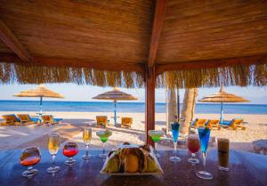 a table with wine glasses on the beach at Nuweiba Club Resort in Nuweiba