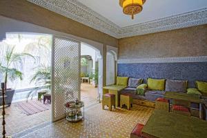 a living room with a couch and a table at Riad Dabachi in Marrakech