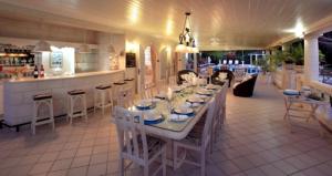 a restaurant with a long table and a bar at 6 BR Vacation Home with Private Pool in Saint James
