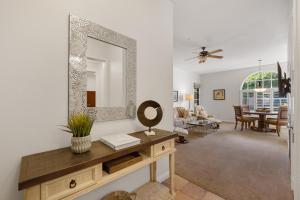 a living room with a mirror and a table at C77-1 Lux 1BD Villa near Clubhouse with all amenities condo in La Quinta