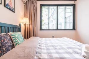 מיטה או מיטות בחדר ב-Shanghai Hills&XING584 Homestay