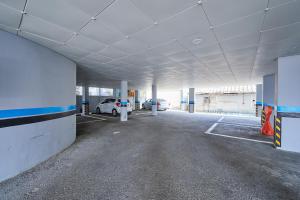 an empty parking garage with cars parked in it at Urban Hotel 