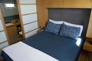 a bed with two pillows in a small room at Albatros-Q in Kaş