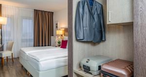 Postel nebo postele na pokoji v ubytování PLAZA INN Karlsruhe Nord